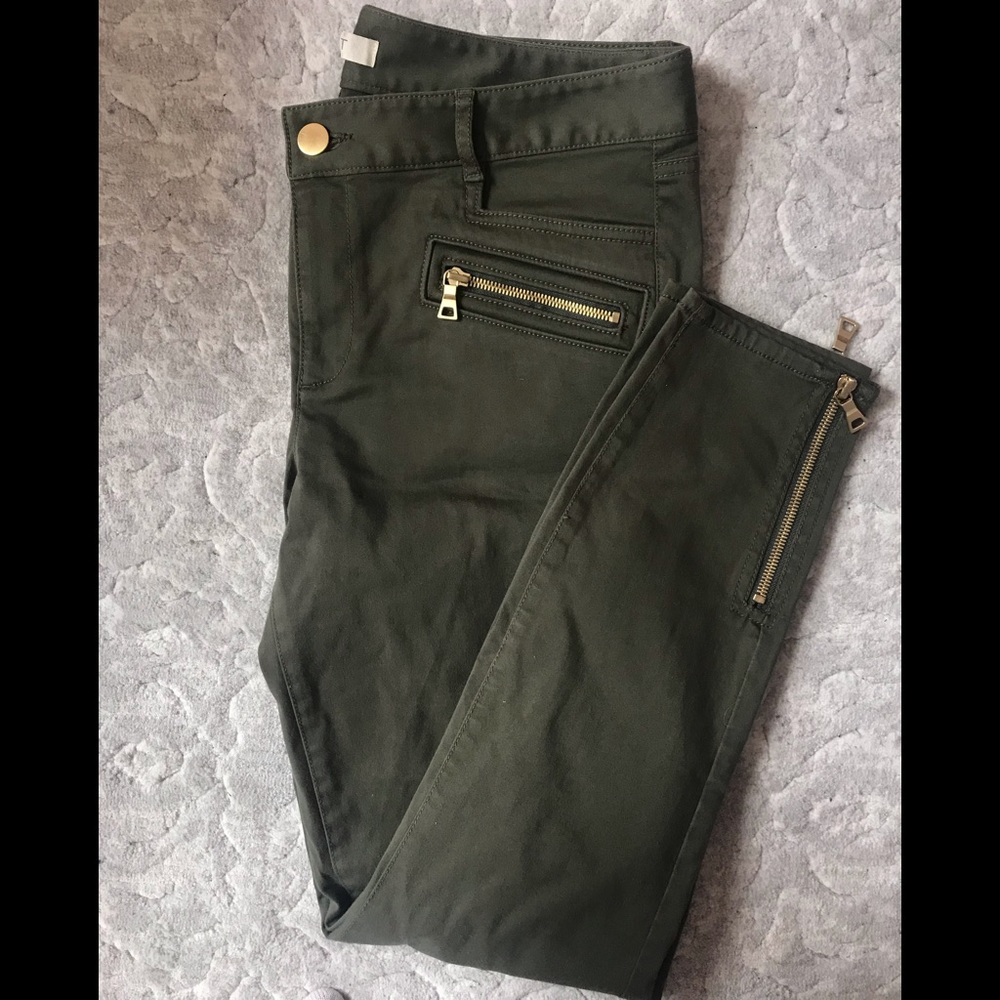 Green pants with gold zipper details